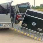 A portable commercial ramp showing a cart loading into a van