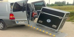 A portable commercial ramp showing a cart loading into a van