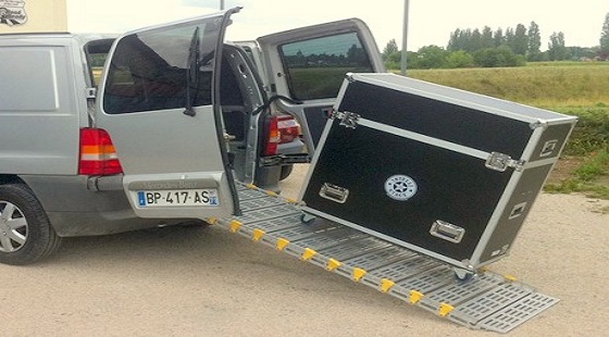 A portable commercial ramp showing a cart loading into a van
